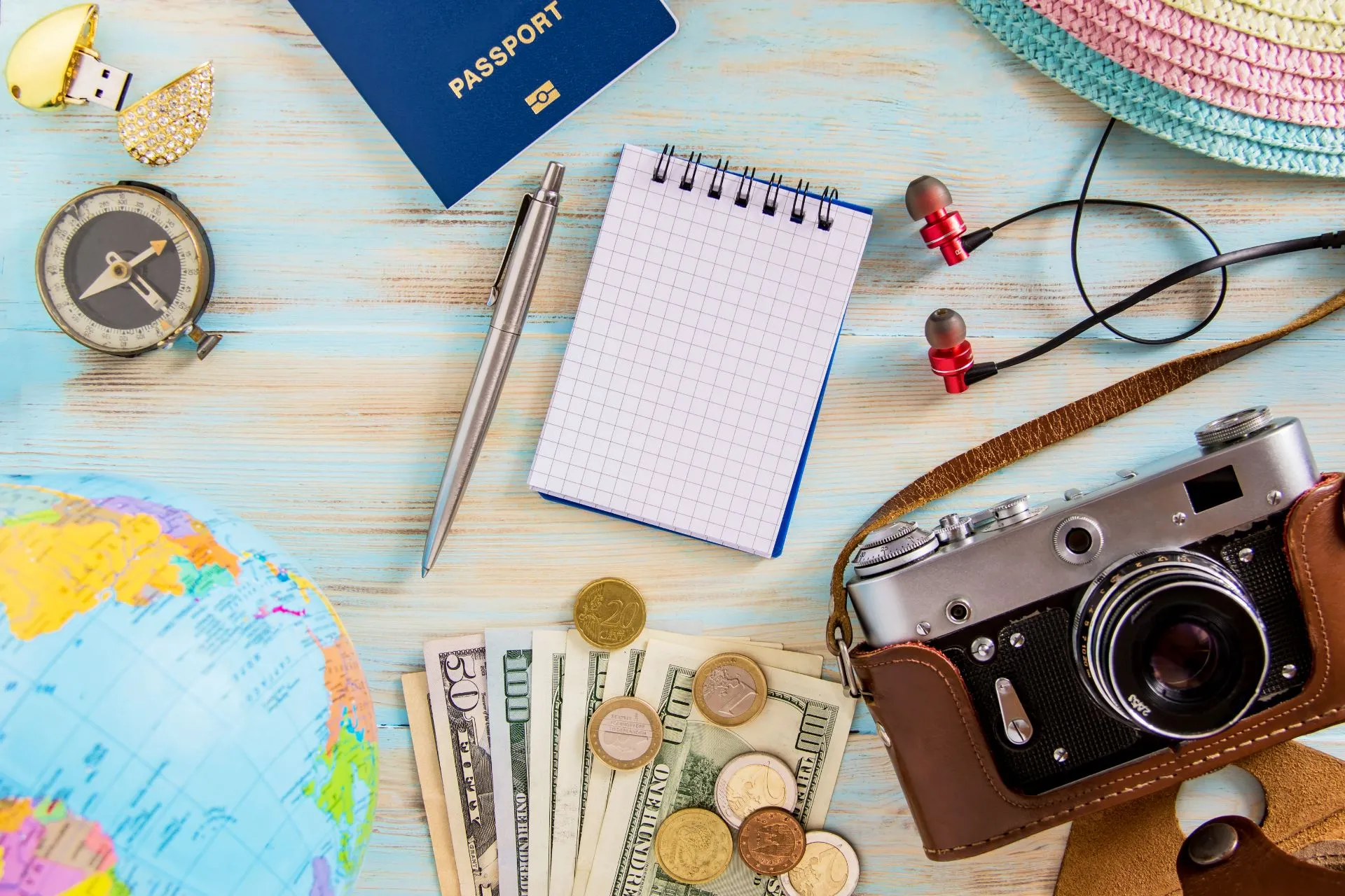 A person writing in a travel journal with a map in the background